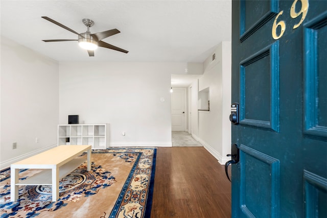 office area featuring ceiling fan, wood finished floors, visible vents, and baseboards