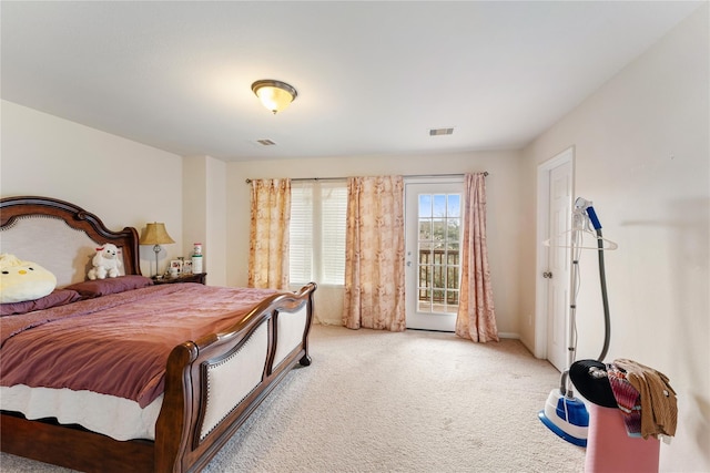 bedroom with light colored carpet, access to outside, and visible vents