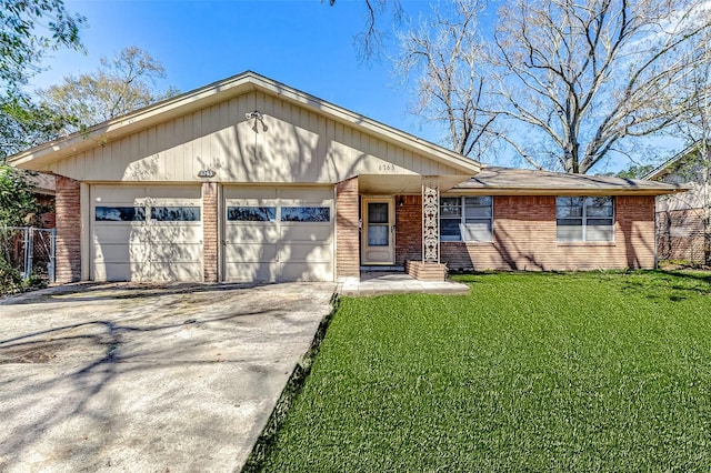 single story home featuring a garage, concrete driveway, brick siding, and a front lawn