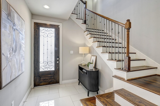 foyer entrance featuring light tile patterned floors, stairway, recessed lighting, and baseboards