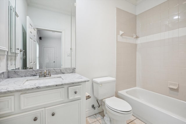 bathroom featuring toilet, vanity, baseboards, tile patterned floors, and washtub / shower combination