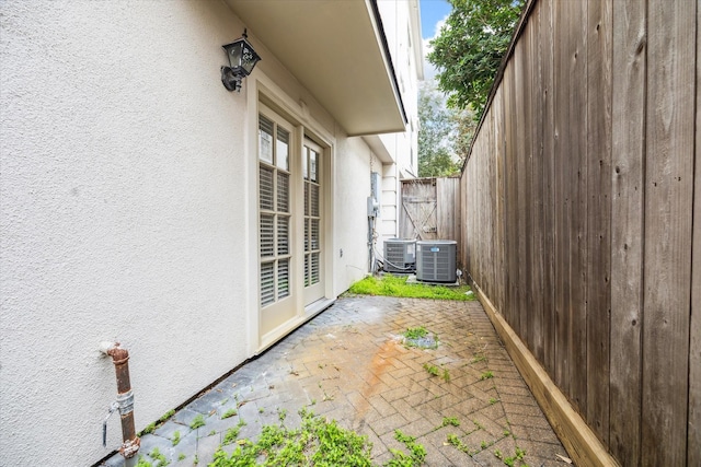 view of patio / terrace featuring fence and central AC unit