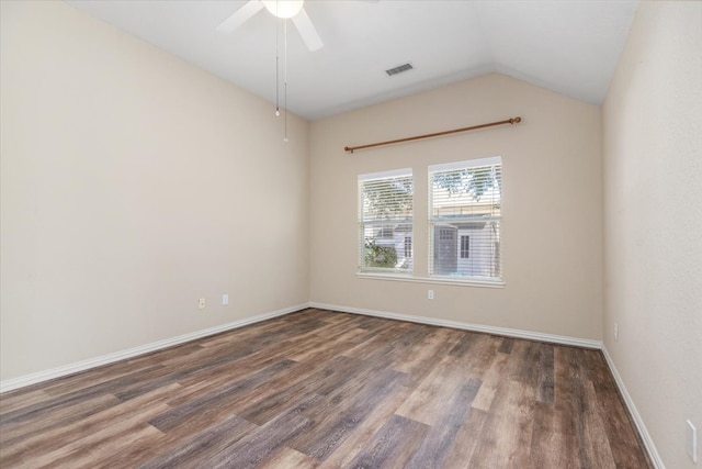 unfurnished room featuring baseboards, visible vents, ceiling fan, dark wood-type flooring, and vaulted ceiling