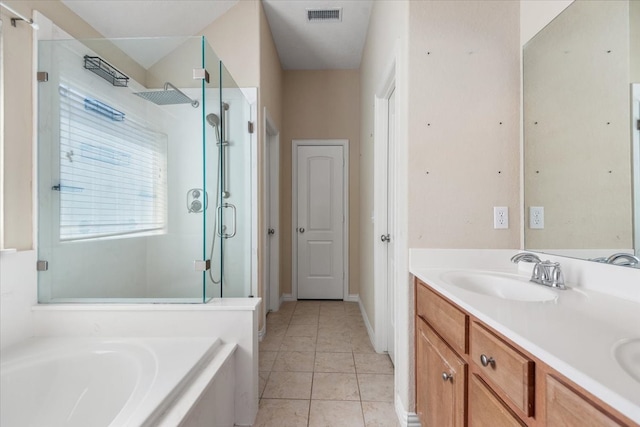 bathroom featuring double vanity, a stall shower, visible vents, a garden tub, and a sink