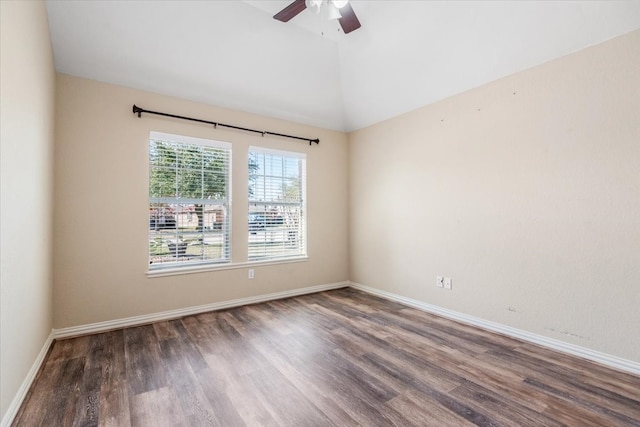 unfurnished room featuring vaulted ceiling, dark wood-type flooring, and baseboards