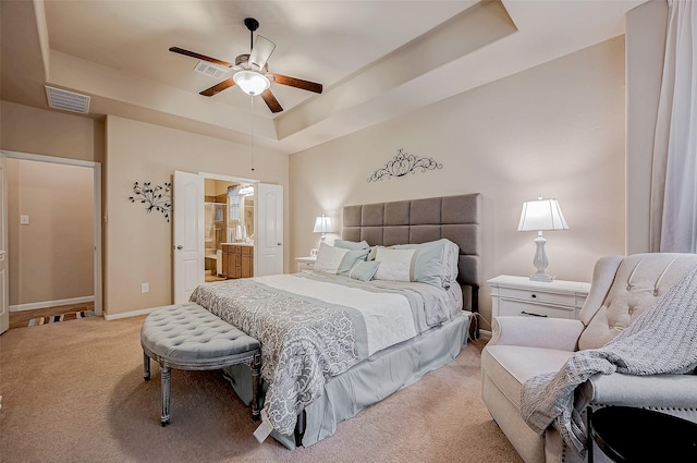 bedroom featuring a raised ceiling, visible vents, light carpet, and baseboards