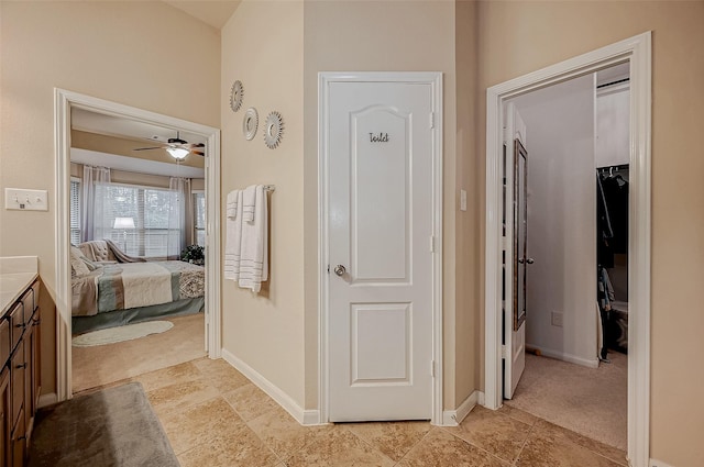 hallway with light carpet and baseboards