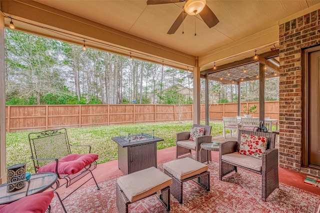 view of patio / terrace with a ceiling fan, an outdoor living space with a fire pit, and a fenced backyard