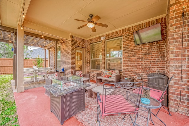 view of patio / terrace featuring an outdoor living space with a fire pit, ceiling fan, and fence