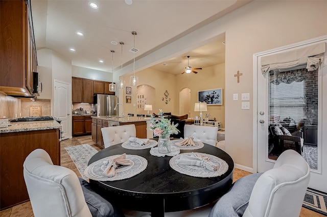 dining room featuring visible vents, arched walkways, a ceiling fan, vaulted ceiling, and recessed lighting