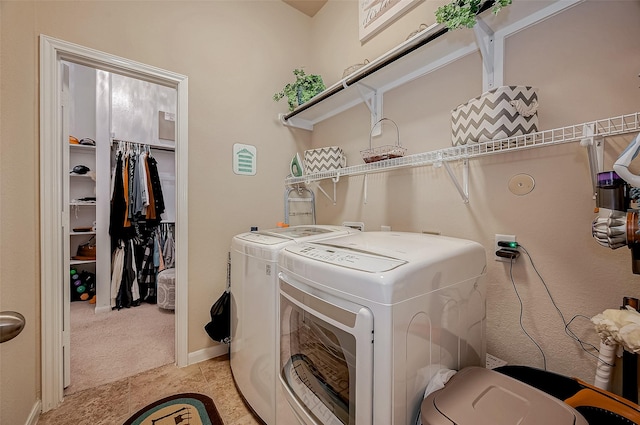 laundry area featuring washer and dryer, laundry area, light colored carpet, and baseboards