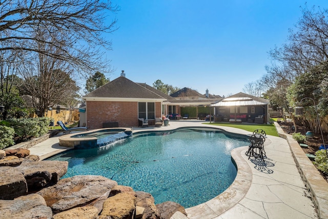 view of pool featuring a pool with connected hot tub, a patio, a gazebo, and fence