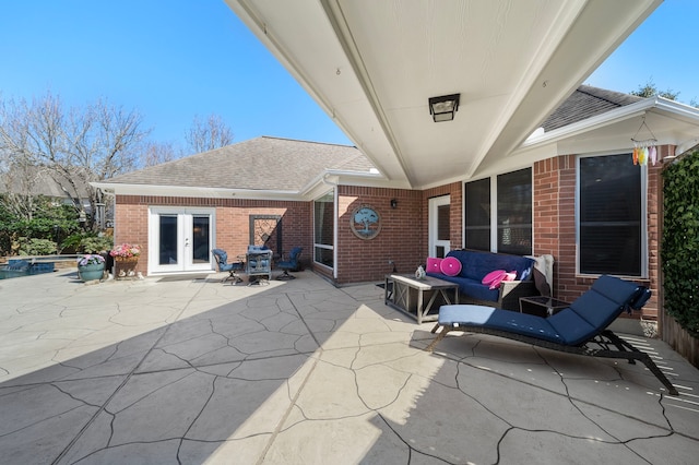 view of patio / terrace featuring french doors, a pool with connected hot tub, and an outdoor living space