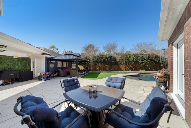 view of patio with a fenced in pool, a grill, fence, a gazebo, and outdoor dining space