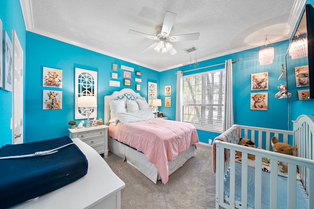 bedroom with a textured ceiling, ceiling fan, light carpet, visible vents, and ornamental molding