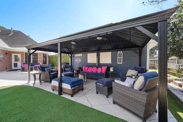 view of patio / terrace featuring fence, outdoor lounge area, and a gazebo