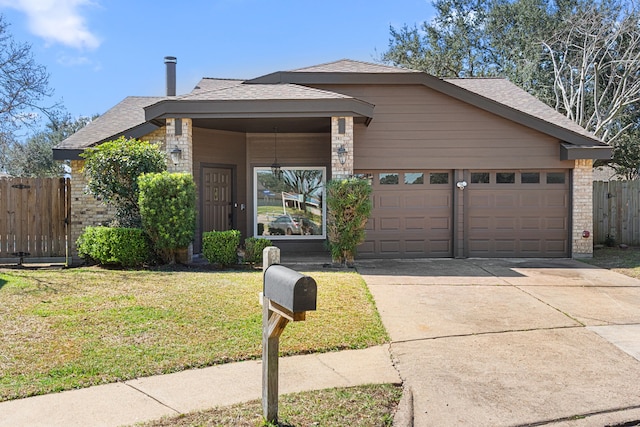 view of front facade with a front lawn, brick siding, fence, and an attached garage