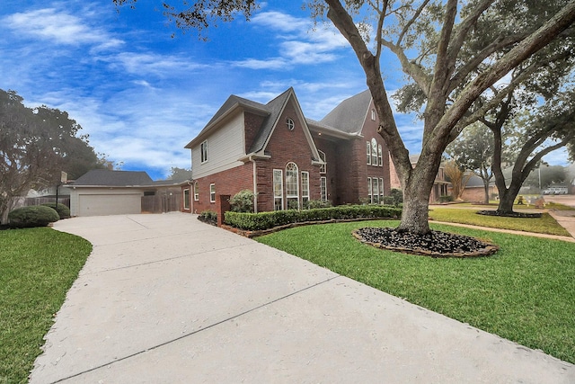 traditional-style home featuring a front yard, concrete driveway, and brick siding