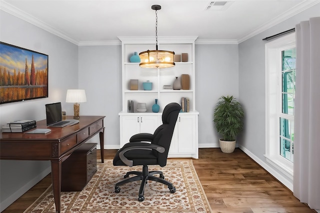 office area with baseboards, crown molding, visible vents, and wood finished floors