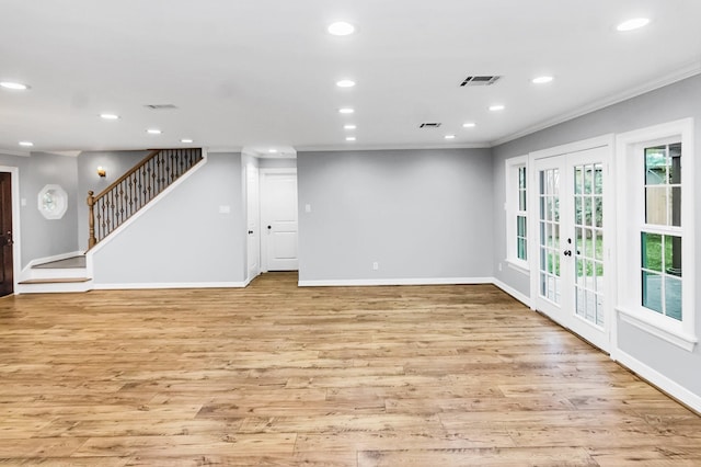 interior space with stairs, ornamental molding, light wood finished floors, and recessed lighting