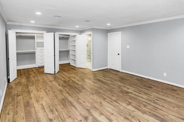 unfurnished bedroom featuring baseboards, crown molding, recessed lighting, and light wood-style floors