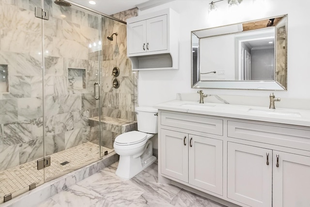 bathroom with a stall shower, marble finish floor, a sink, and double vanity