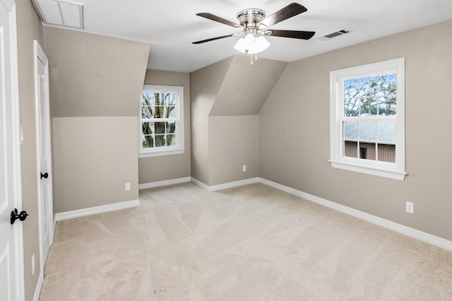 bonus room featuring baseboards, a wealth of natural light, visible vents, and light colored carpet