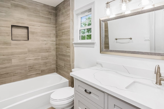 bathroom with tub / shower combination, vanity, and toilet