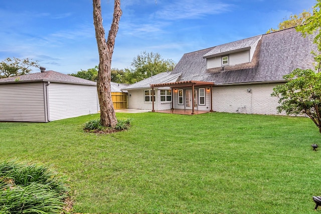 back of house with a lawn, a patio area, and a pergola