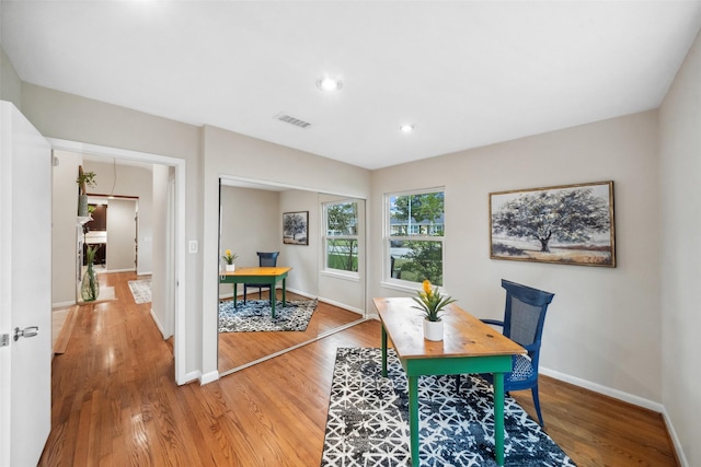 office space featuring baseboards, visible vents, wood finished floors, and recessed lighting