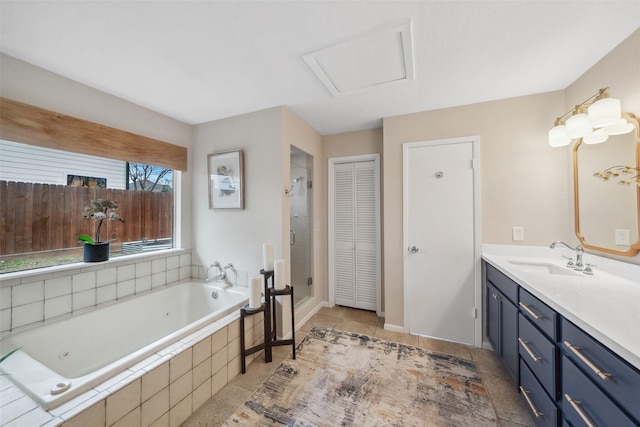 full bathroom featuring a closet, a garden tub, vanity, and tile patterned floors