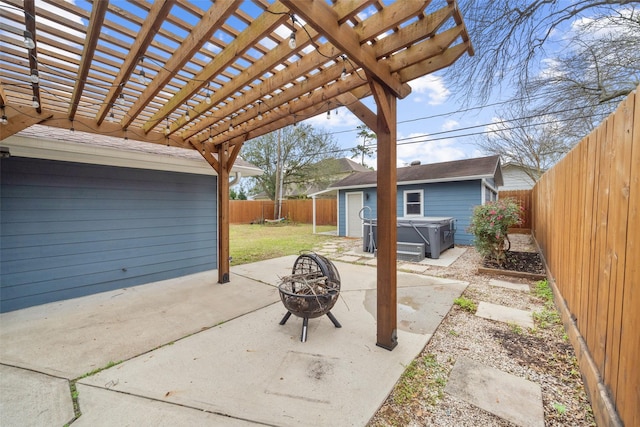 view of patio / terrace with an outbuilding, an outdoor fire pit, a fenced backyard, a pergola, and a hot tub