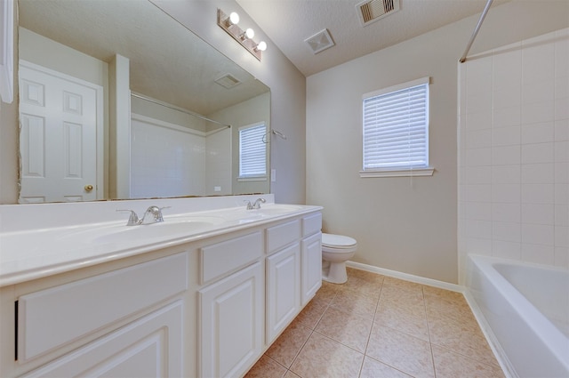 bathroom with a textured ceiling, toilet, a sink, visible vents, and tile patterned floors