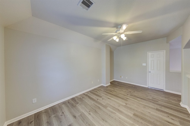 empty room with light wood-style floors, ceiling fan, visible vents, and baseboards