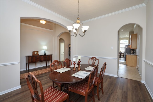 dining room with a chandelier, baseboards, wood finished floors, and ornamental molding