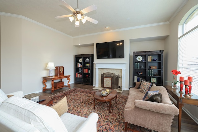 living room with a wealth of natural light, a fireplace with flush hearth, ornamental molding, and wood finished floors