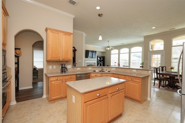 kitchen with a kitchen island, a peninsula, a sink, light countertops, and dishwasher