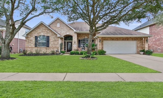 view of front facade featuring brick siding, a shingled roof, a front lawn, concrete driveway, and an attached garage