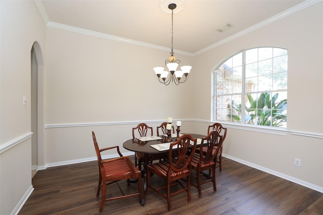 dining room with wood finished floors, baseboards, visible vents, arched walkways, and crown molding