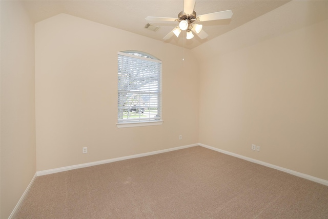 spare room featuring visible vents, carpet floors, lofted ceiling, and ceiling fan