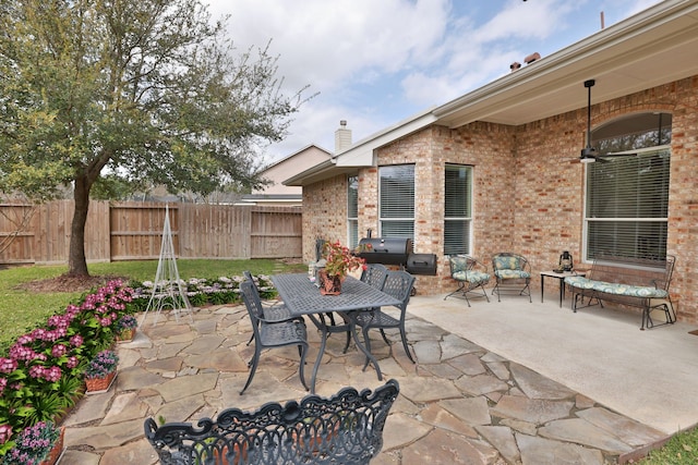 view of patio with outdoor dining area and fence