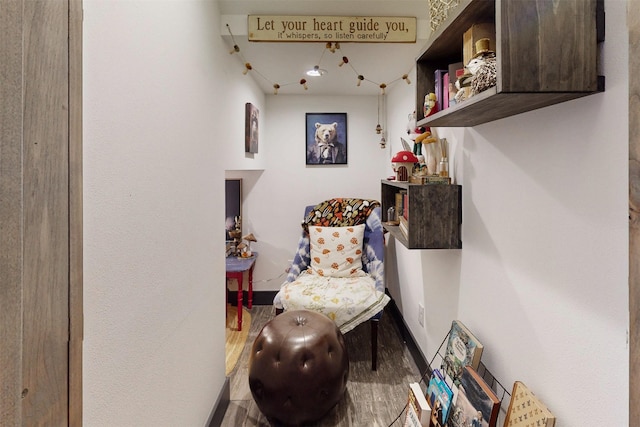 living area featuring baseboards and wood finished floors