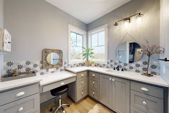 full bath with vanity, decorative backsplash, and wood finished floors