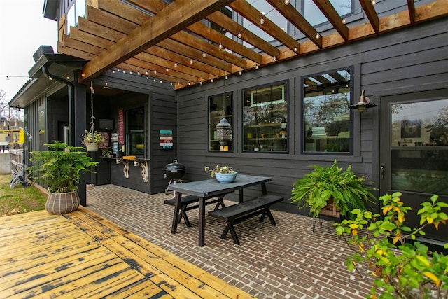 view of patio featuring a wooden deck and a pergola