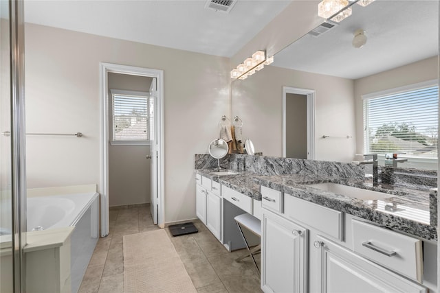 full bathroom featuring double vanity, a garden tub, visible vents, and a sink