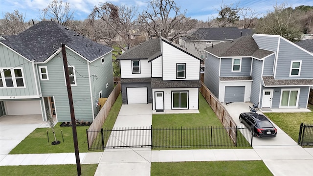 view of front of home featuring an attached garage, driveway, roof with shingles, a residential view, and a front yard