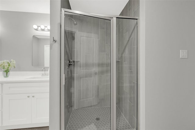 bathroom featuring a shower stall and vanity