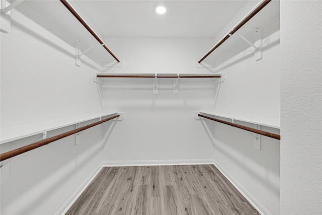 walk in closet featuring light wood finished floors