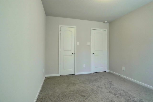 unfurnished bedroom with light carpet and baseboards