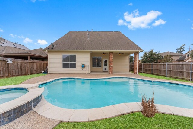 view of pool with a fenced backyard, a pool with connected hot tub, a patio area, and ceiling fan